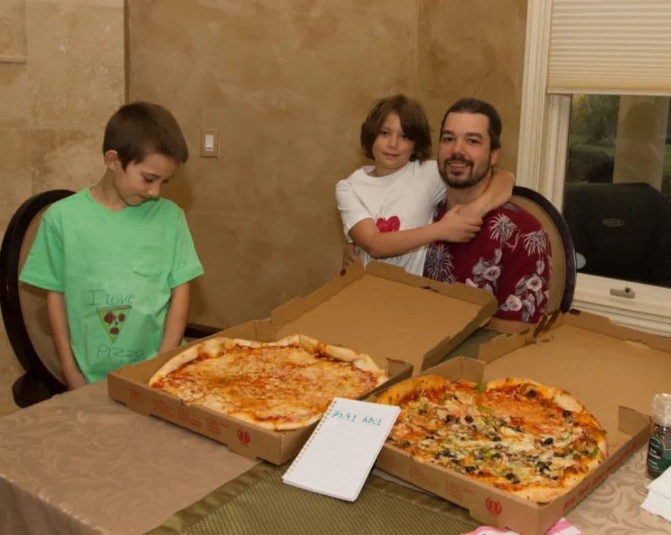 Den glade pizzakjøperen og hans barn, sammen med de historiske pizzaene